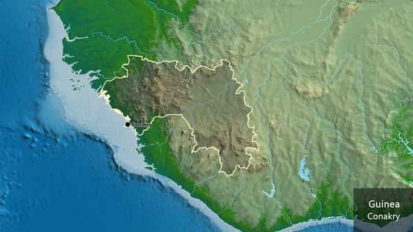 ギニア国境地帯のクローズアップは 物理的な地図上の暗いオーバーレイで強調されています 資本ポイント 国の形の周りの概要 英名国とその首都 — ストック写真