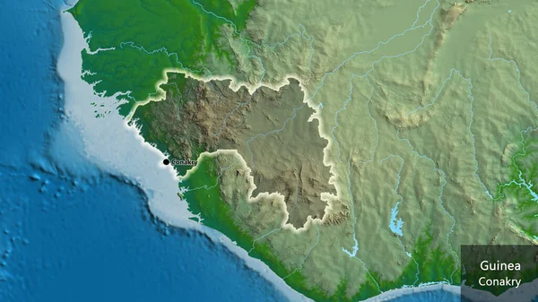 ギニア国境地帯のクローズアップは 物理的な地図上の暗いオーバーレイで強調されています 資本ポイント 国の形の周りに光る 英名国とその首都 — ストック写真