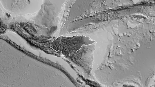 Honduras sınır bölgesinin, gri tonlamalı bir haritada koyu bir örtüyle ışıklandırılması. Ana nokta. Ülke şekli etrafında özet geç. 