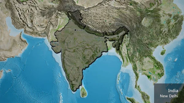 Close-up of the India border area highlighting with a dark overlay on a satellite map. Capital point. Bevelled edges of the country shape. English name of the country and its capital