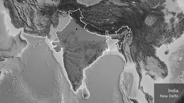 Close-up of the India border area highlighting with a dark overlay on a grayscale map. Capital point. Outline around the country shape. English name of the country and its capital