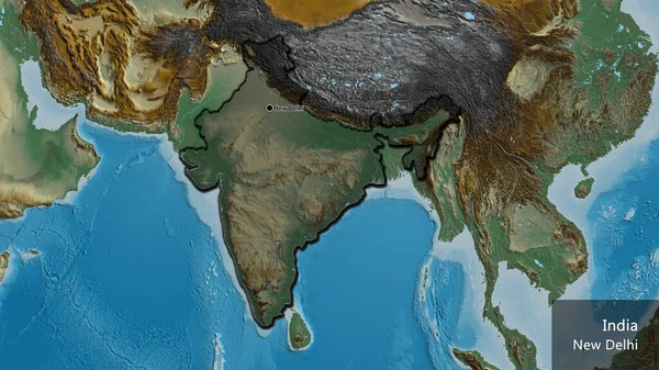 Close-up of the India border area highlighting with a dark overlay on a relief map. Capital point. Bevelled edges of the country shape. English name of the country and its capital