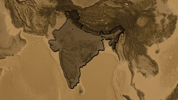 Close-up of the India border area highlighting with a dark overlay on a sepia elevation map. Capital point. Bevelled edges of the country shape.