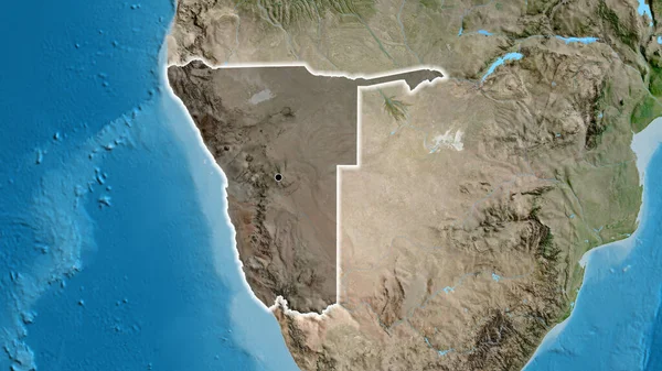 Close-up of the Namibia border area highlighting with a dark overlay on a satellite map. Capital point. Glow around the country shape.