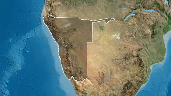 Close-up of the Namibia border area highlighting with a dark overlay on a satellite map. Capital point. Outline around the country shape.
