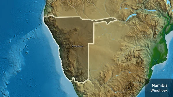 Close-up of the Namibia border area highlighting with a dark overlay on a physical map. Capital point. Glow around the country shape. English name of the country and its capital