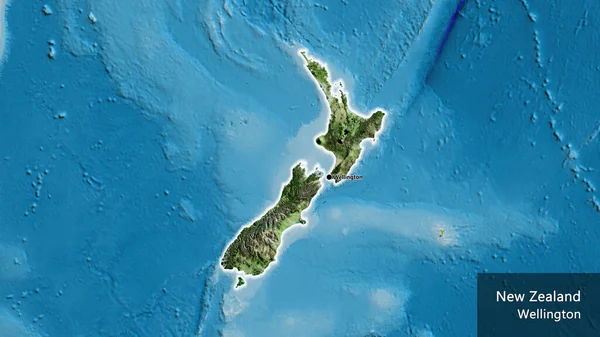 Yeni Zelanda sınır bölgesinin uydu haritası üzerinde yakın plan görüntüsü. Ana nokta. Ülke çapında parıldıyor. Ülkenin ve başkentinin İngilizce adı