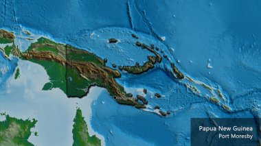 Papua Yeni Gine sınır bölgesinin yakın çekimleri fiziksel bir haritada koyu bir örtüyle vurgulanıyor. Ana nokta. Kırsal kesimin kıvrımlı kenarları. Ülkenin ve başkentinin İngilizce adı