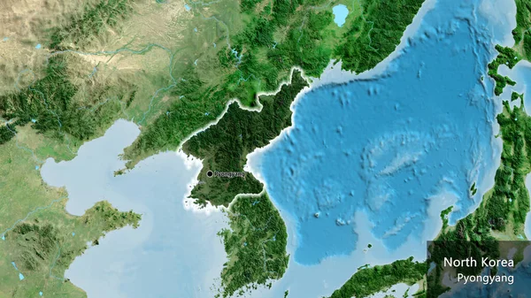 Close-up of the North Korea border area highlighting with a dark overlay on a satellite map. Capital point. Glow around the country shape. English name of the country and its capital
