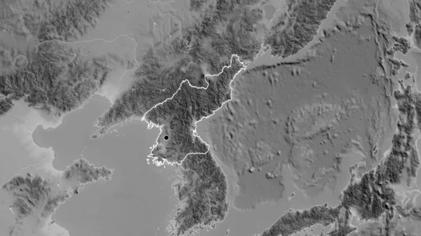 Close-up of the North Korea border area on a grayscale map. Capital point. Outline around the country shape.
