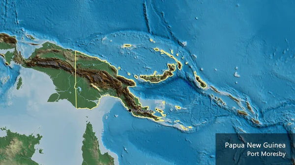 在一张救济地图上对巴布亚新几内亚边境地区进行了密切的调查 资本点 概略地描述一下国家的面貌 国家及其首都的英文名称 — 图库照片