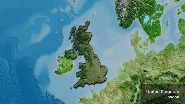 stock image Close-up of the United Kingdom border area highlighting with a dark overlay on a satellite map. Capital point. Bevelled edges of the country shape. English name of the country and its capital