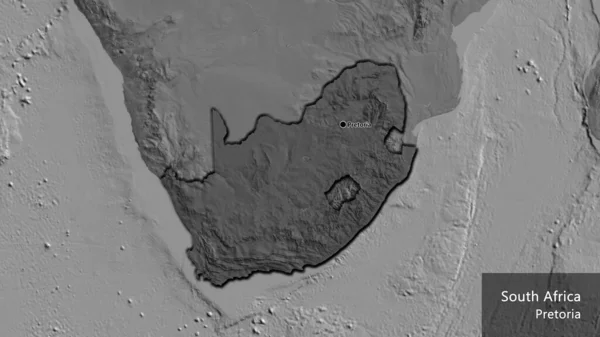 Close-up of the South Africa border area highlighting with a dark overlay on a bilevel map. Capital point. Bevelled edges of the country shape. English name of the country and its capital