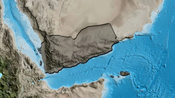 stock image Close-up of the Yemen border area highlighting with a dark overlay on a satellite map. Capital point. Bevelled edges of the country shape. 