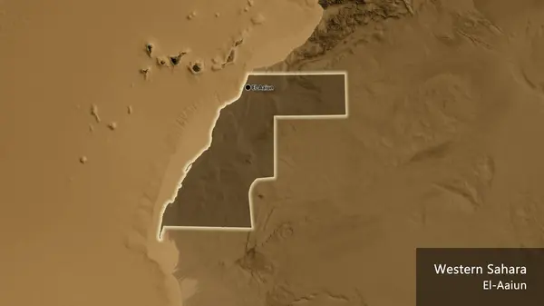 Close-up of the Western Sahara border area highlighting with a dark overlay on a sepia elevation map. Capital point. Glow around the country shape. English name of the country and its capital