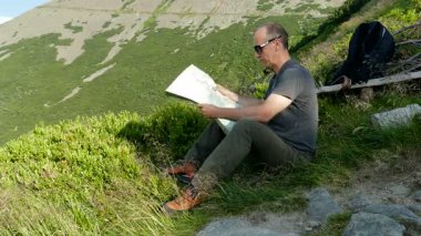 Dağlardaki Turist Haritadaki İzleri Kontrol Ediyor