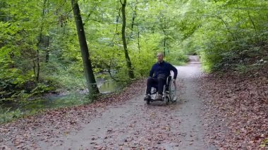 Tekerlekli bir orman parkta Engelli adam