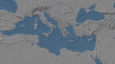 Patterson silindirik projeksiyonunda dünyanın mavi ve gri renkli yükseklik haritasının arka planında İyon Denizi bölgesi