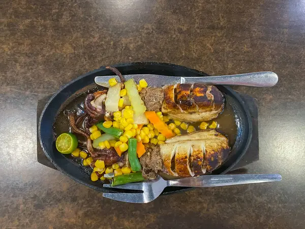 Grilled squids with vegetables in a frying pan. High quality photo