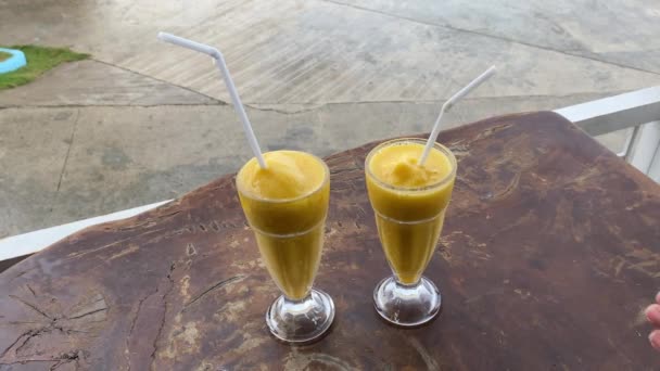 Two Glasses Mango Shake Hand Takes Glass High Quality Footage — Stock Video