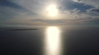 Okyanus üzerinde günbatımı yüksek irtifadan gökyüzü manzarası, denizdeki tropikal adalar