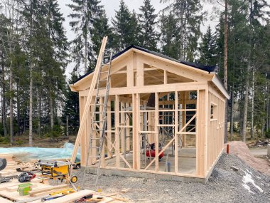 Ormanın arka planına karşı ahşaptan yapılmış bir çerçeve inşa etme süreci.. 