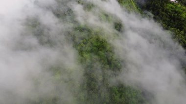 Tropikal dağların üzerindeki bulutların üzerinden uçan hava manzarası, bulutlar denizi.