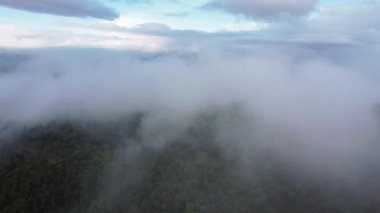 Tropikal dağların üzerindeki bulutların üzerinden uçan hava manzarası, bulutlar denizi.