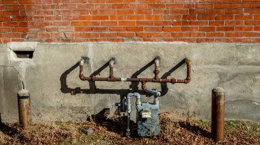 Company gas meter along the side of a building