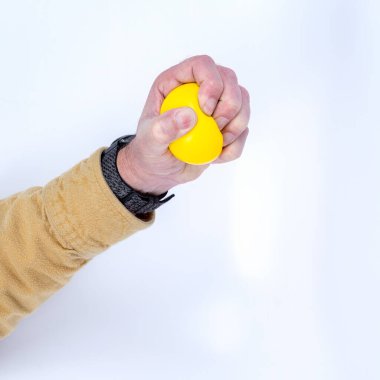 Yellow stress ball in use