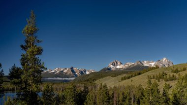 Idaho forest and Sawtooth mountains and lake clipart