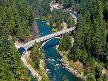 Payette River and Rainbow bridge with deep green forest clipart