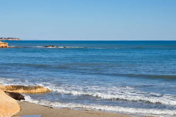 Striking scene of waves breaking on the sand of a Spanish beach