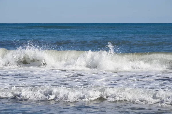 Striking scene of waves breaking on the sand of a Spanish beach