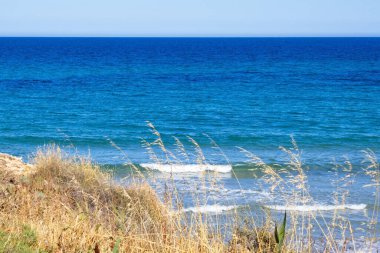 Striking scene of waves breaking on the sand of a Spanish beach