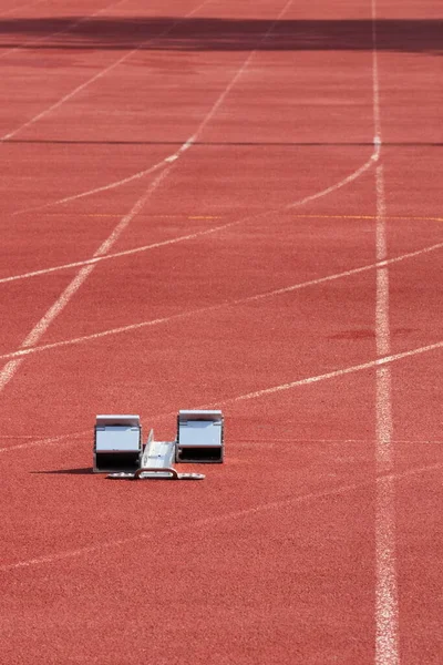 Stock image Synthetic running track for sporting events with starting blocks