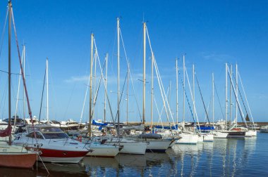 Gün batımında deniz kıyısında bir yat iskelesi..