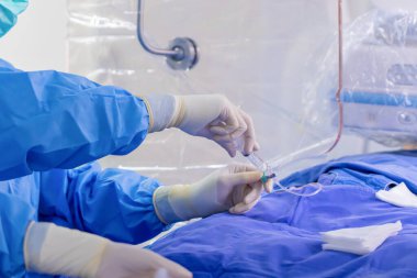 surgeon team working in operating room, Stem cells operation, Plasma in syringe, Health care concept.