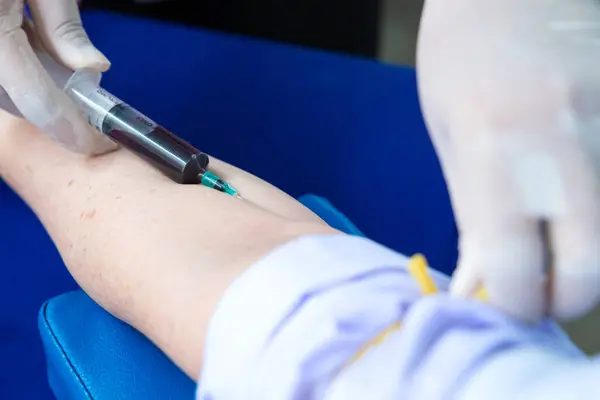 stock image Nurse collecting a blood from patient in hospital.