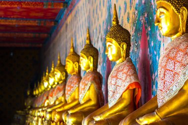 Row of Golden Buddha statue religion culture tradition in Thailand