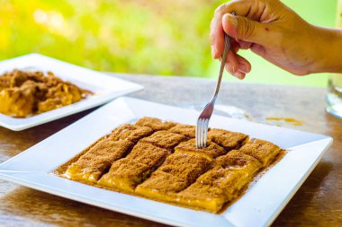 Roti Bakar Bandung or Bandung Bread Toast i served often with butter, cheese, stwarberry jam, Green tea, crushed peanuts and sugar,