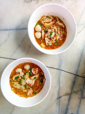 Thai Style Tom Yum Noodles with Minced Pork Spicy soup with wooden chopsticks