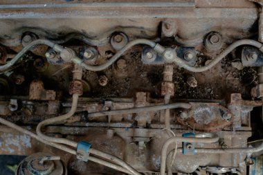 A detailed image of an aged, rusty engine block showcasing fuel lines, bolts, and metal textures. Perfect for industrial, mechanical, or automotive design themes, this photograph captures the worn yet intricate beauty of vintage machinery components clipart