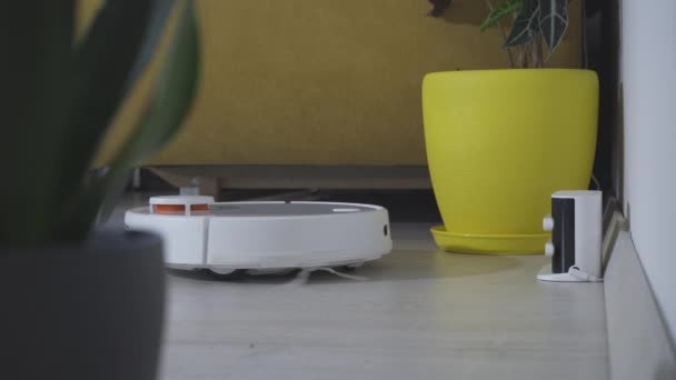 現代のスマート電子ハウスキーピング技術 ロボット掃除機はテーブルの周り スマートセンサーをきれいにします 高品質4K映像 — ストック動画