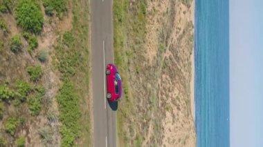 red car side view drone follow near sea . High quality FullHD footage