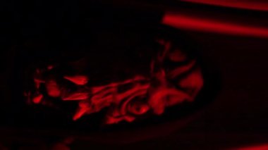 vertical video of scary mask hides behind red curtain surprice concept. High quality 4k footage