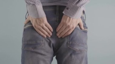 A man experiencing discomfort due to painful haemorrhoids, is evidently in an unhealthy state. High quality 4k footage