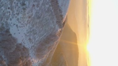 amazing winter sunset vertical video of beautiful snowy mountain landscape . High quality FullHD footage