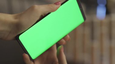 vertical video of hands swipe on Phone with Green screen lifestyle mock up. High quality FullHD footage