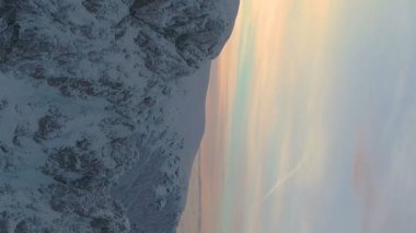 vertical video of winter scenery snowy mountain outdor awesome color sunset . High quality FullHD footage